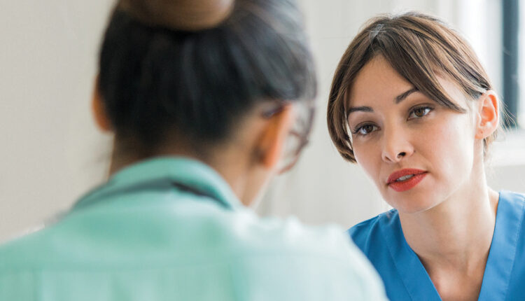 Dental hygienist speaking with patient
