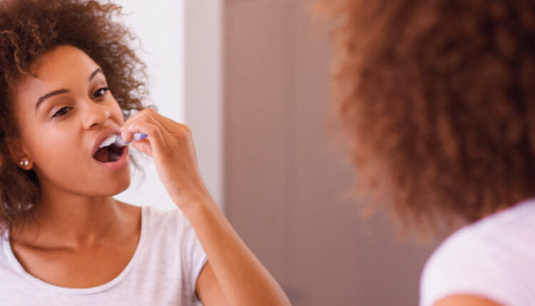 woman brushing teeth