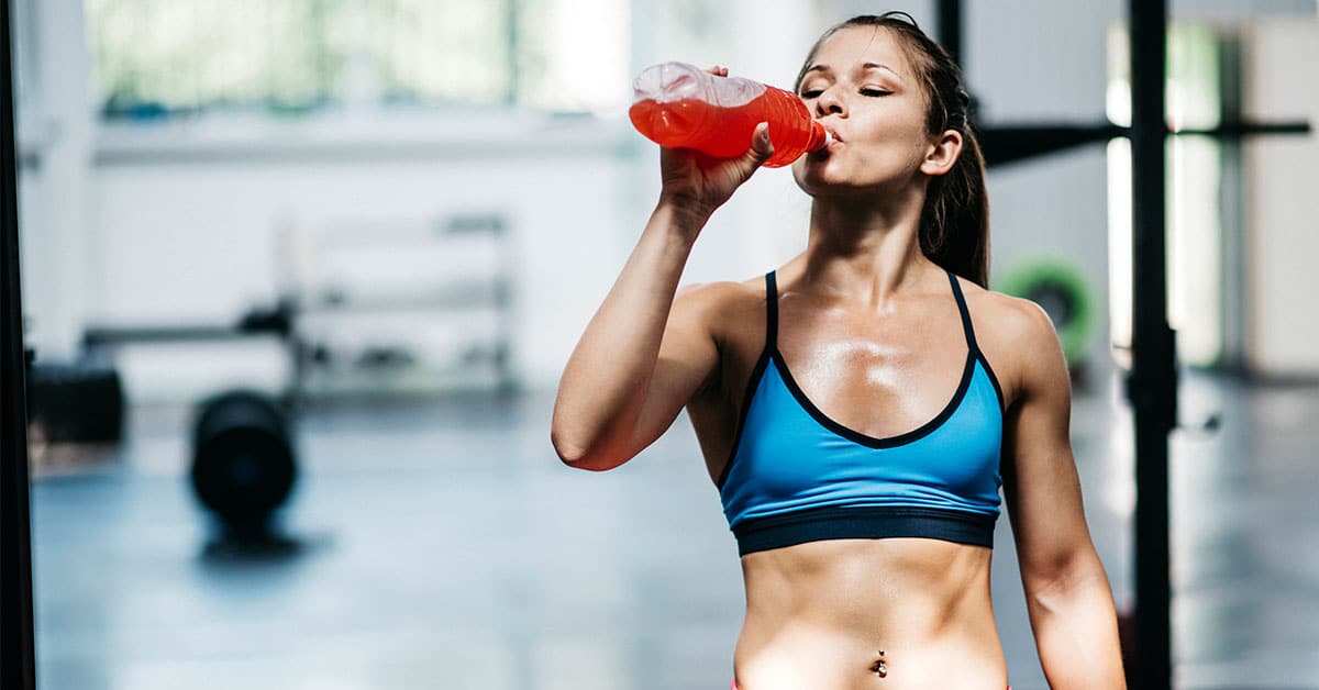 Woman drinking a sports drink.