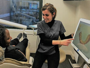 Dental hygienist uses an intraoral scanner