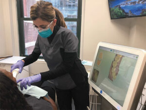 Dental hygienist using a intraoral scanner.