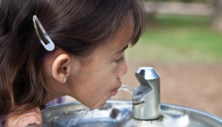 Girl drinking water with fluoride
