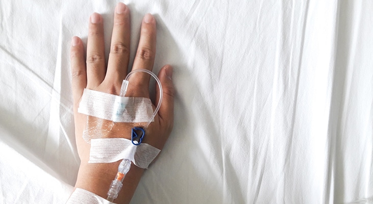 Patient hand with the tube of normal saline infusion