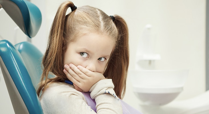 girl sitting in dentist chair