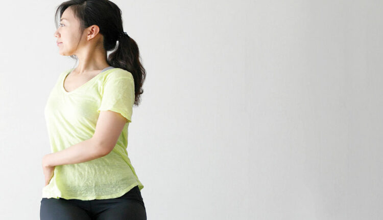 Woman practicing chair yoga