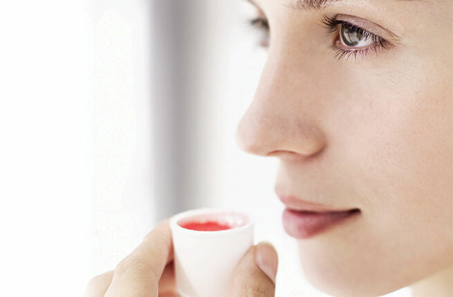 Woman using mouthrinse