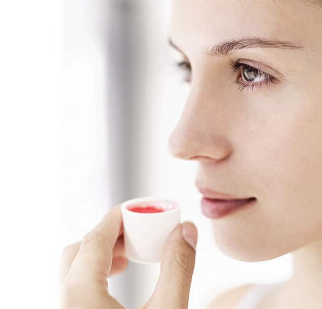 Woman using mouthrinse