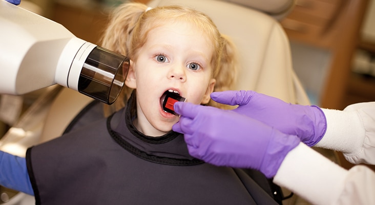 young girl getting dental xrays