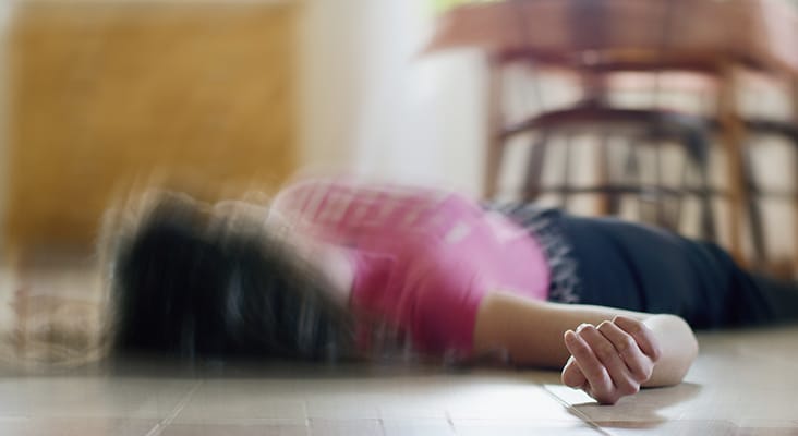 Woman lying on the floor at home, epilepsy, unconsciousness, faint, stroke, accident or other health problem, healthcare and medical concept