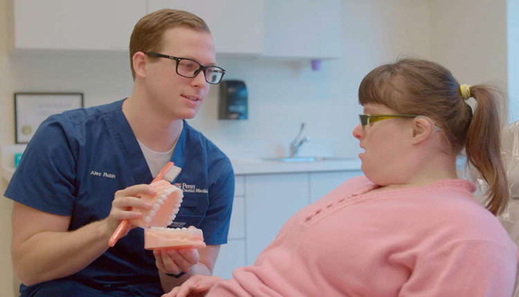 Clinican explains dental treatment to patient with special needs