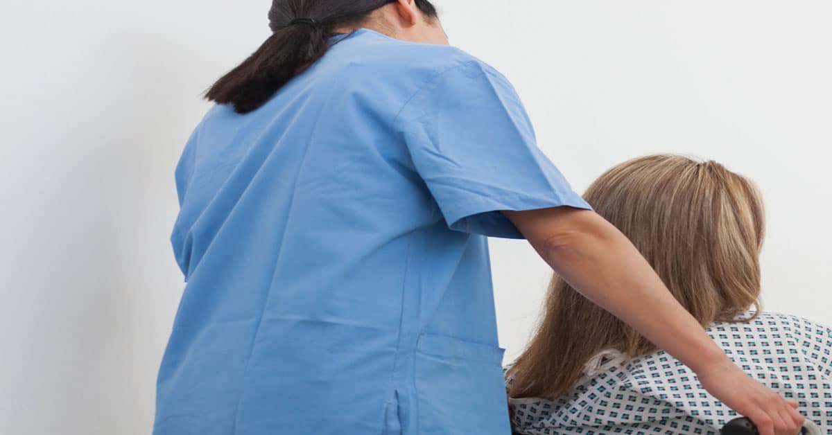 Clinician helping a patient with Cerebral Palsy