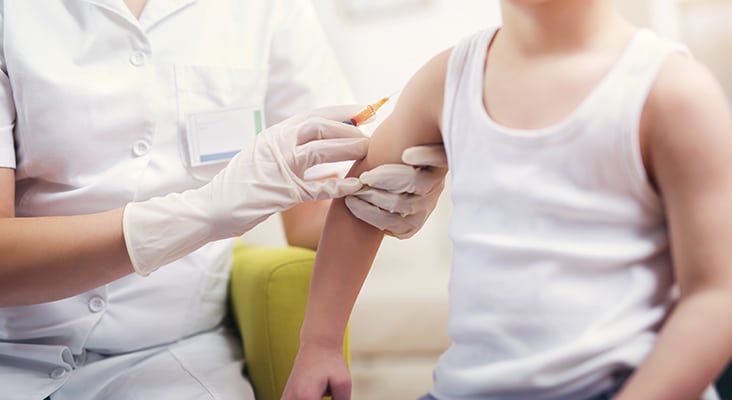 Pediatrician gives vaccination to small boy