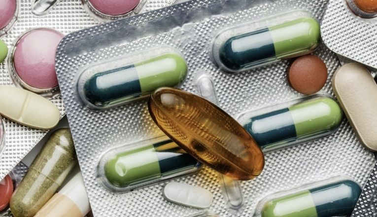 Background of a large group of assorted capsules, pills and blisters