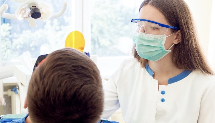 rofessional dentist with patient in hospital