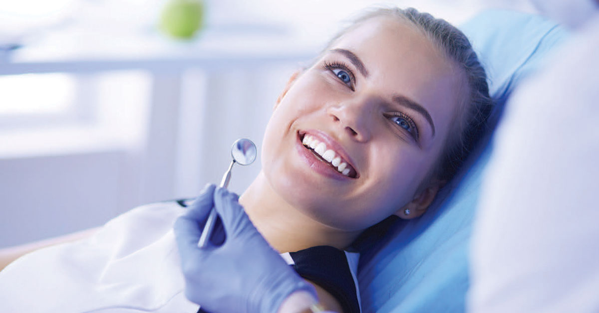 Woman in dental chair smiling