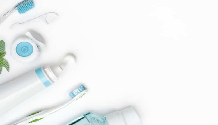 Dental cleaning tools and hygiene products on white