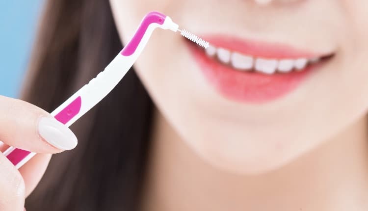 close up of woman take interdental brush