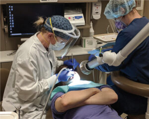 Figure 2. With the help of a dental assistant, Alisha Hinrichs, LDA, Heather Luebben, ADT, LDH, performs a restorative procedure at Apple Tree Dental’s Mounds View Center in Mounds View, Minnesota, where she is the only advanced dental therapist.