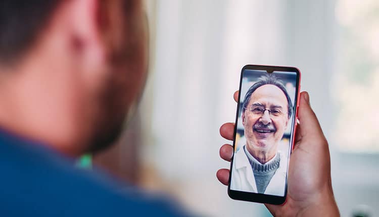 Patient talking to a doctor online through a mobile phone