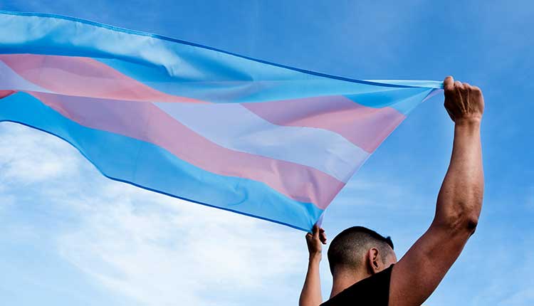 young person with a transgender pride flag