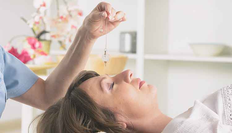 Therapist using pendulum to make a diagnosis