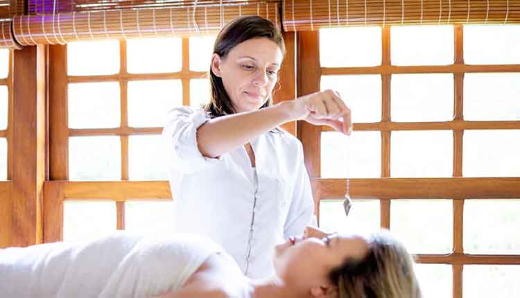 Therapist using pendulum to make diagnosis