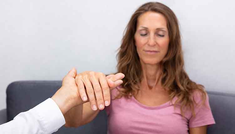 Hypnotherapist Holding Woman Hand During Hypnotherapy