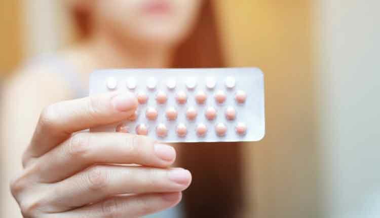 woman holding contraceptive pack
