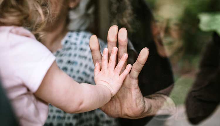 Little Girl Visits Grandparents Through Window -