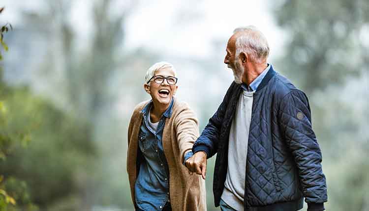 Playful senior couple having fun in the park