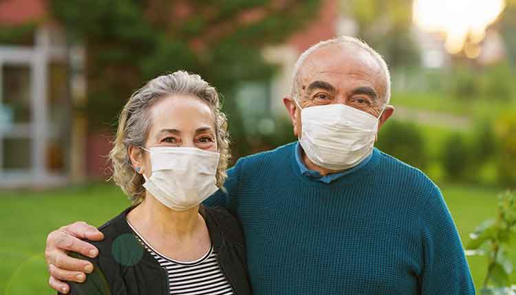 Senior couple on front of their house during COVID-19 quarantine