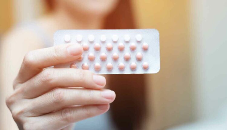 Woman holding contraceptive birth control pills