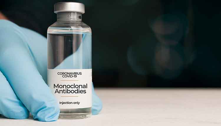 Doctor hold a vial of monoclonal antibodies , a new treatment for coronavirus Covid-19, on a white table