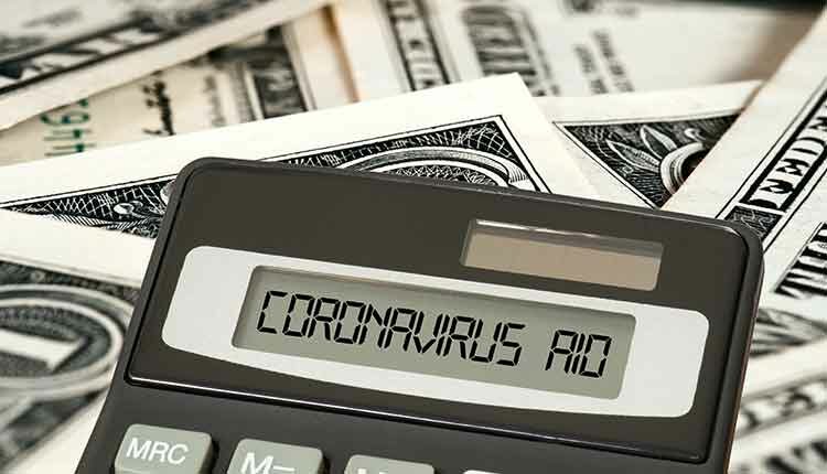 Dollar banknotes, calculators and aid package Coronavirus in USA
