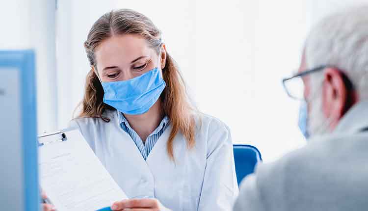 Young female doctor explaining prescription to her elderly patient