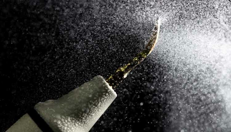 Dental ultrasonic scaler with water splash on black background. Close up.