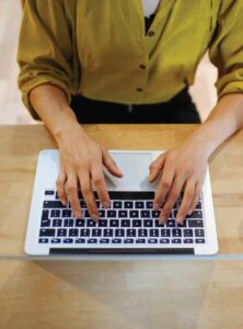 somebody typing on a laptop