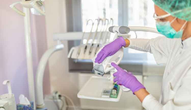 Female doctor cleaning dental office