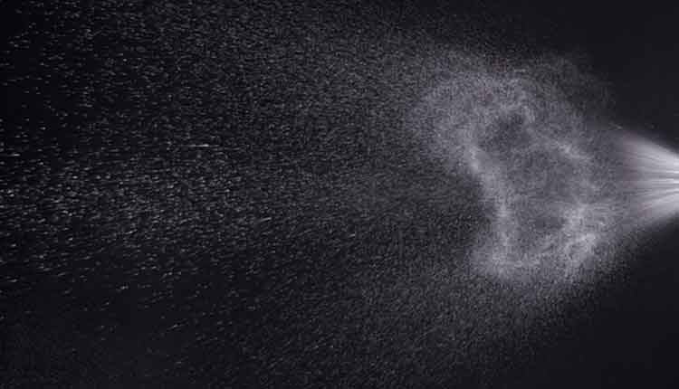 a spray of liquid in a black background.