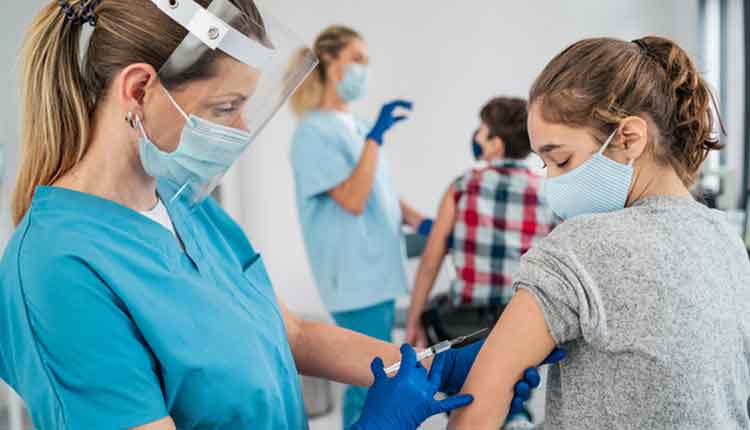 Doctor vaccinating girl. Injecting COVID-19 vaccine into patient's arm