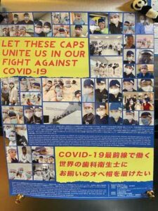 Poster reading let these caps unite us in our fight against COVID-19