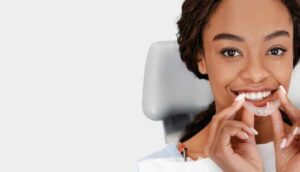 woman putting in clear aligner