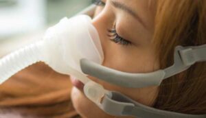 woman wearing sleep apnea mask