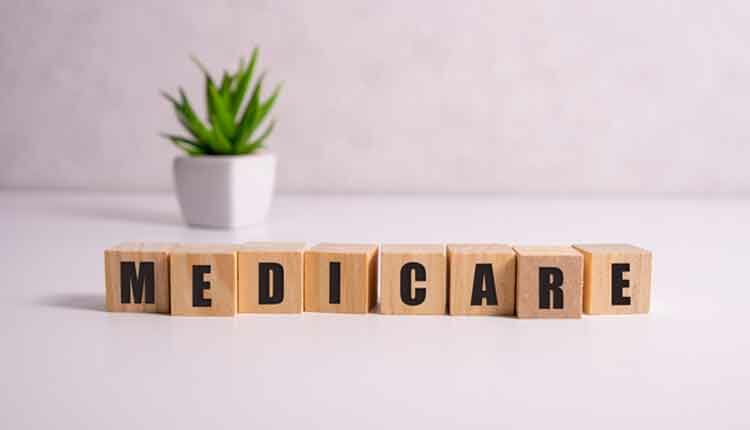 MEDICARE word made with building blocks, medical concept background.