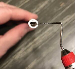 FIGURE 2.A saliva ejector showing the 4 mm opening with a probe.