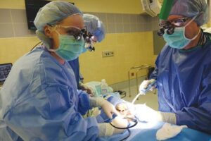 FIGURE 2. The dental prevention coordinator performs scaling and root planing in the hospital operating room while the patient is treated under general anesthesia.