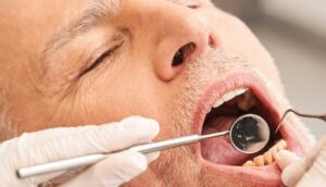 elderly man getting dental exam