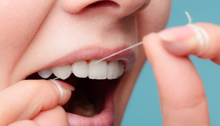 Side view woman face smiling with dental floss