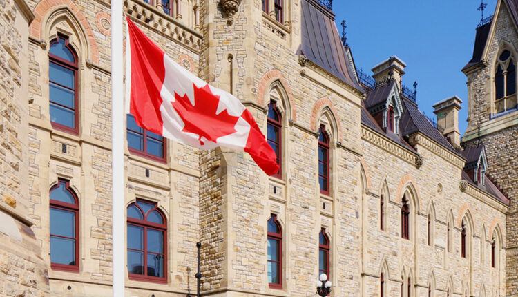 Canadian flag at half-mast in front of the Canadian parliament building