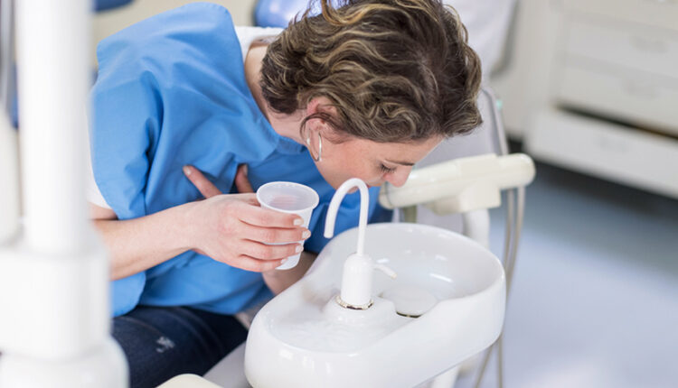Dental patient washing out her mouth